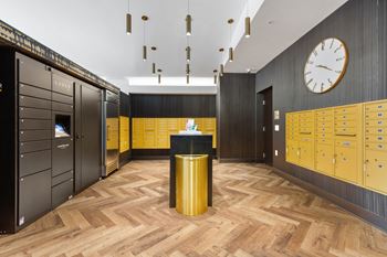 a locker room with yellow lockers and a clock on the wall at Rialto, Washington, DC 20002